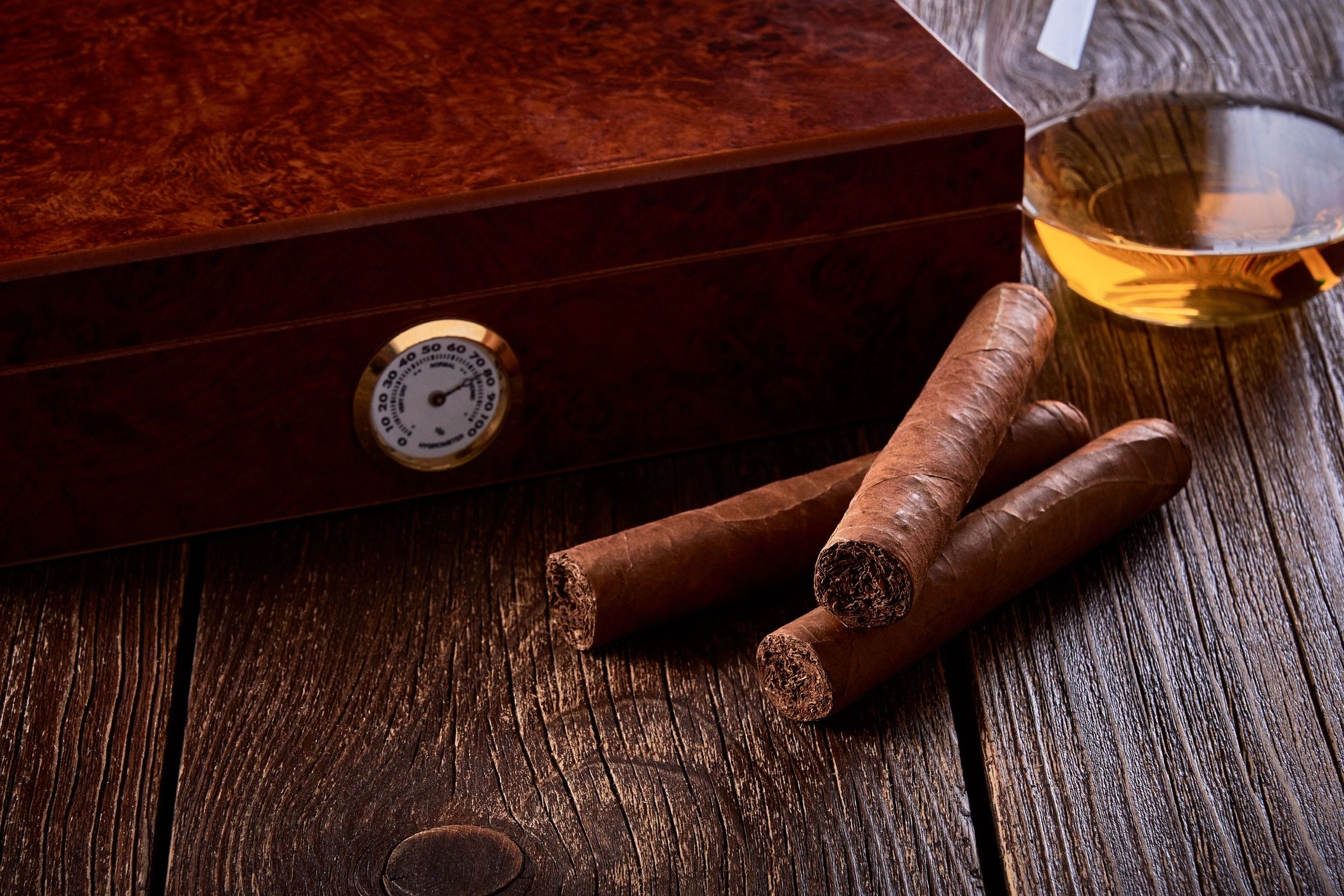 Whiskey glass and bar accessories on a wooden table