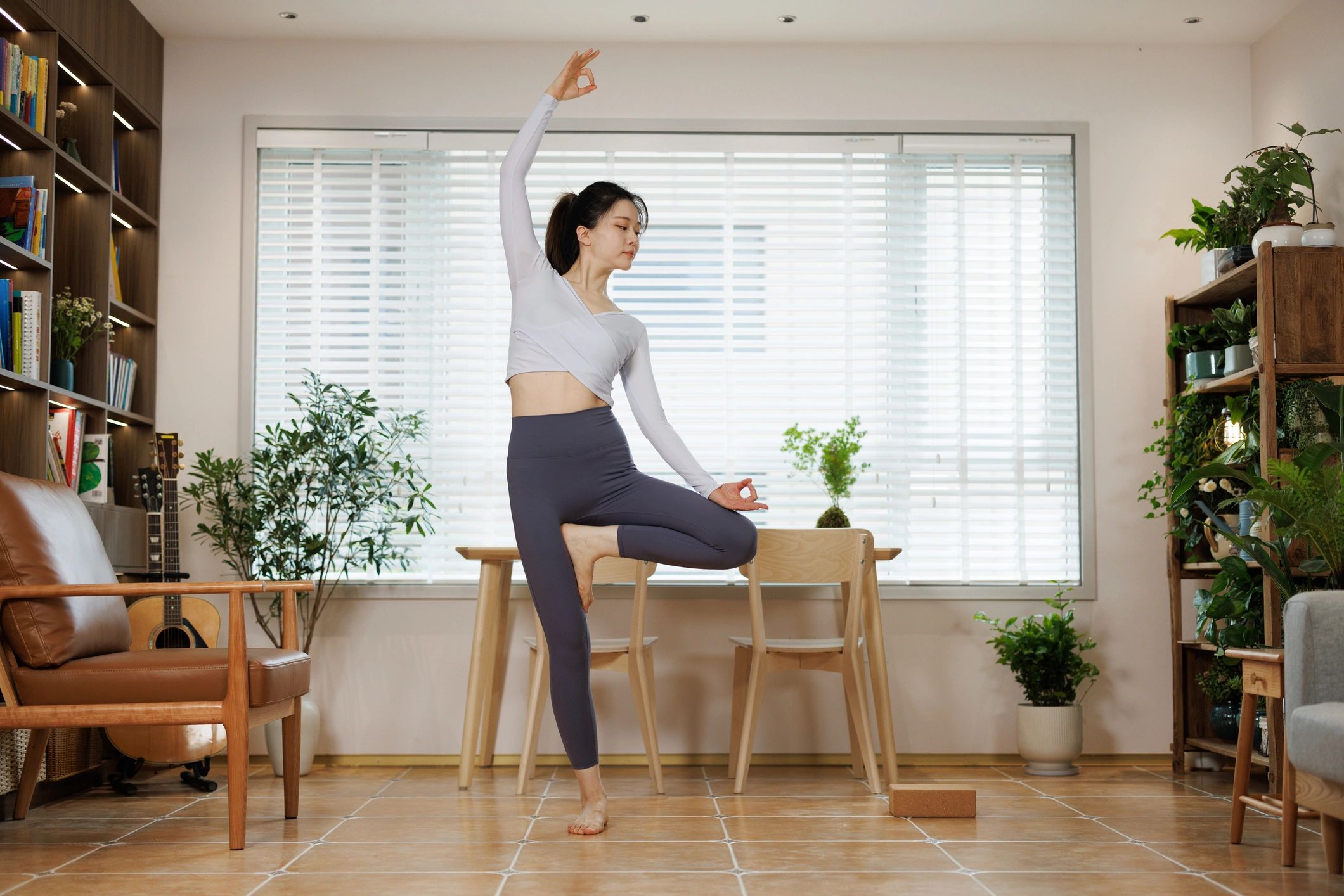 Woman practicing yoga in a bright room