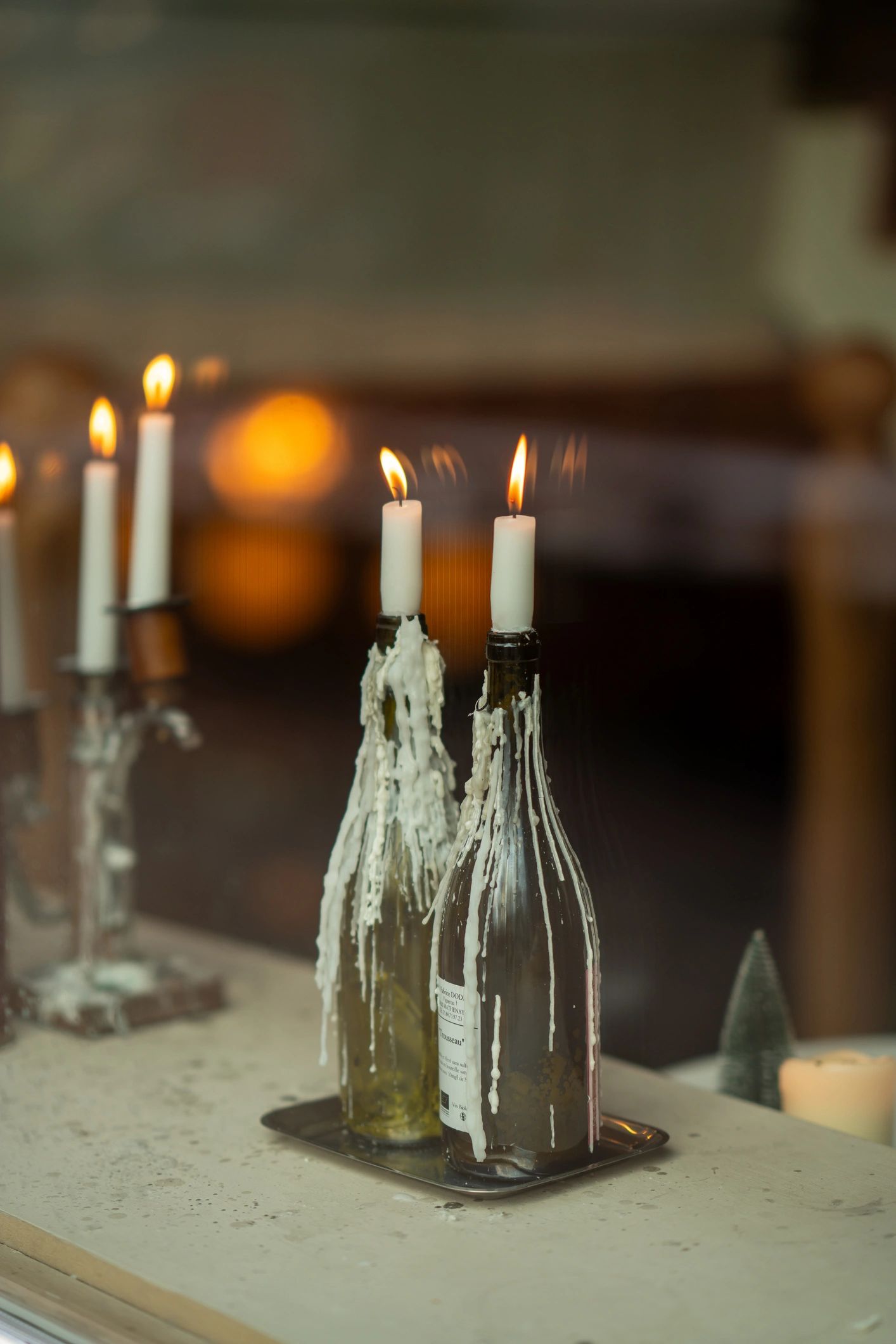 Wine bottles glowing with candlelight