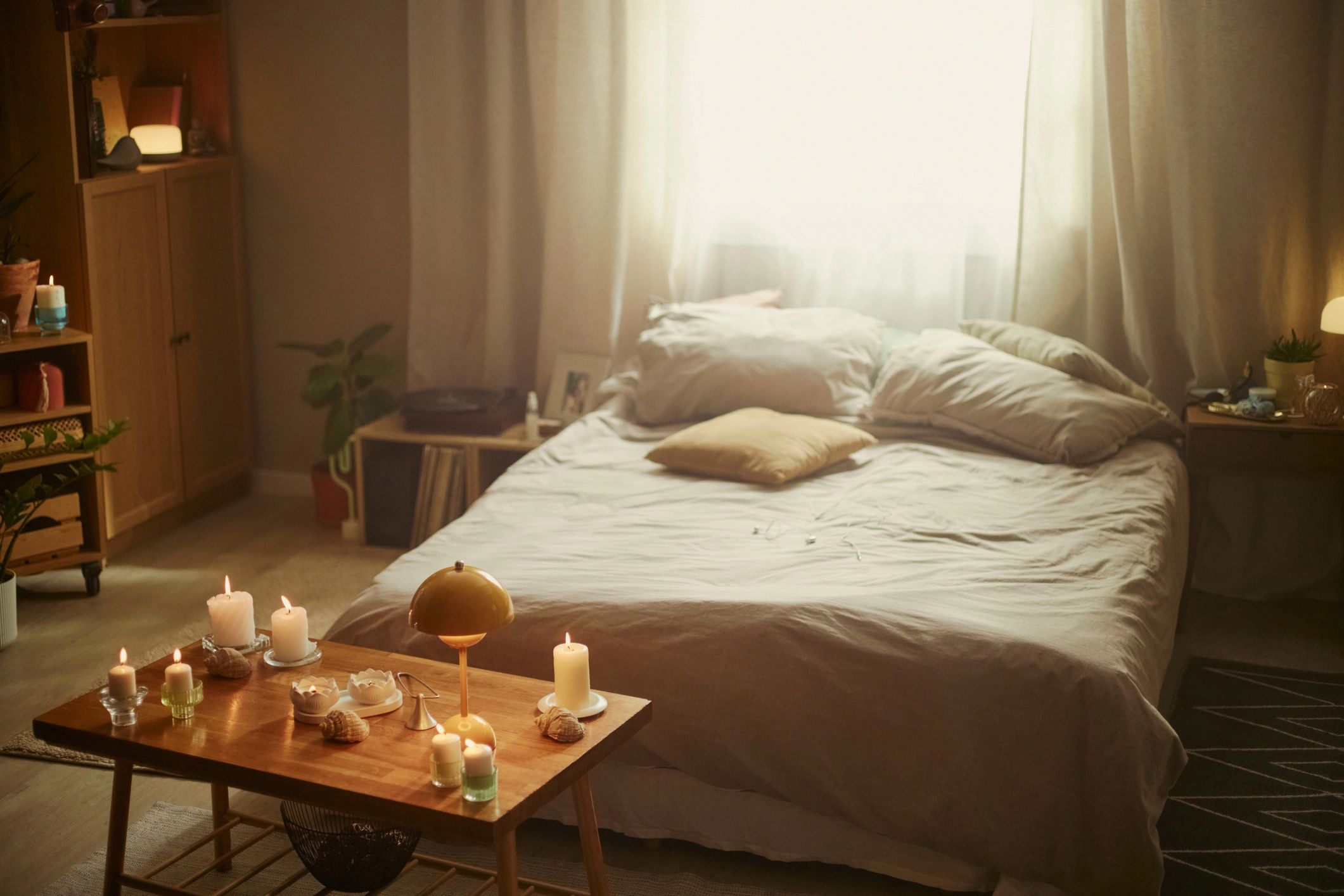 Cozy bedroom wellness ritual with candles