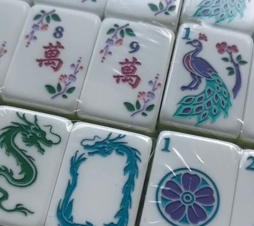Botanical mahjong tiles with floral, peacock, and dragon motifs